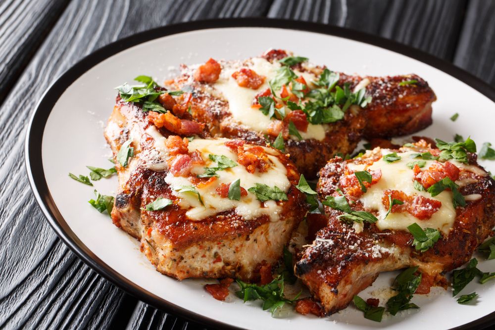 Spicy grilled pork chops with melted cheese.
